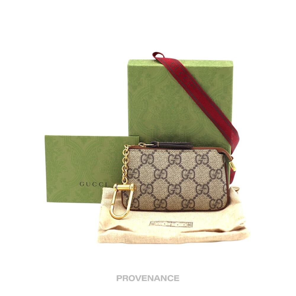 Gucci GG Supreme Beige Brown Signature Pouch with Gold Hardware and Red Strap
